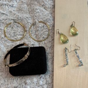 Gold Hoop and Green Drop Earrings. Gold bracelet.